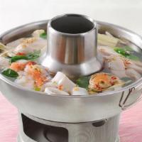 Spicy Seafood Soup/Poh Tak · Seafood lemongrass soup with mussels, shrimp, fish, calamari, crab leg, tomatoes, onion, cil...