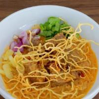 Kao Soi · Special curry sauce with coconut milk, egg noodle, red onion, lime, chili oil, pickled, and ...