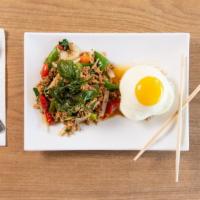 En10. Pad Garpow Kai Dow · Stir-fried grounded chicken with basil, bell pepper, thai chili, and fried egg on top.