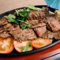 Tiger-Cry · 8oz. Grilled marinated sirloin steak. Served with spicy thai taste sauce, cucumber, tomatoes...