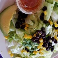 Tepozteca Salad · Lettuce, corn, black beans, cilantro, onions, and avocado slice with house vinaigrette on th...