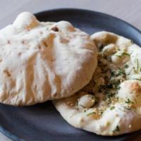 Garlic Naan · freshly baked homemade white flour Indian bread with fresh garlic and cilantro.. [contains g...