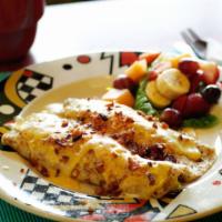 Crepe Cena · Sautéed spinach and onions in a scrambled egg-filled crepe topped with hollandaise and garni...