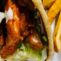 Buffalo Chicken Wrap · Tender strips of breaded chicken tenders, dipped in Buffalo sauce with shredded lettuce and ...