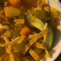 Bowl Chicken Tortilla Soup · Chicken and vegetable soup topped with tortilla strips and cheese.