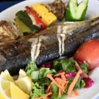 Fresh Mediterranian Branzin (Gluten Free) · Choco-grilled full fish served with spices and rice or vegetables skewer.