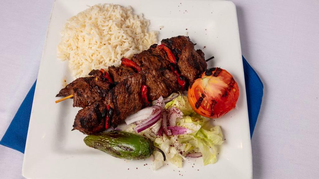 Adana Kebob (Gluten Free) · Skewer of beef and lamb marinated with peppers and onion served on flat bread, served with rice.