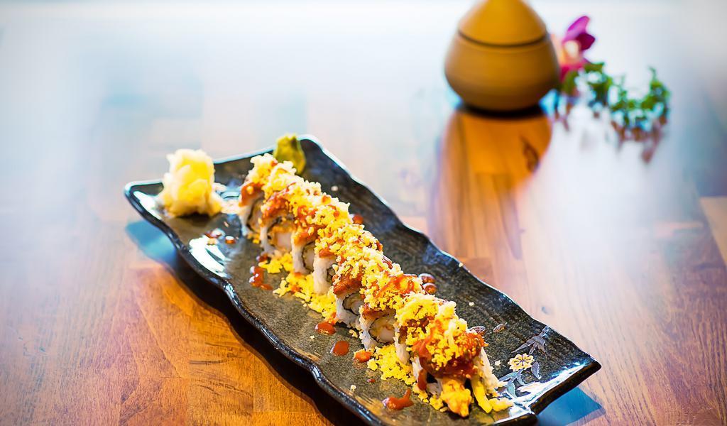 Oishii Roll · Shrimp tempura, avocado, and cucumber topped with spicy tuna, tempura bits and special house sauce.