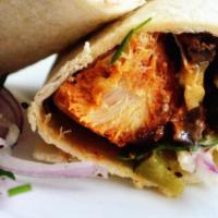 Shish Tawook · Grilled tender chicken chunks on tortilla bread with puckles and garlic sauce.