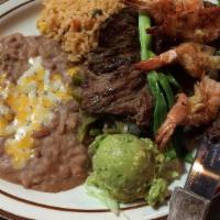 Mar Y Tierra · Marinated arrachera steak and sauteed shrimp with garlic butter. Served with re-fried beans,...