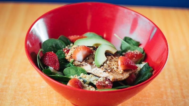 Strawberry Spinach Salad · Fresh spinach, red onion, strawberries, cucumbers, walnuts and avocado served with strawberry balsamic dressing.