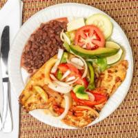 #2. Pollo A La Plancha · Grilled chicken served with salad, avocado, cheese, lemon, rice, beans and tortillas.