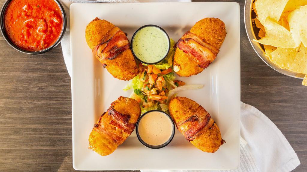 Fronteras Poppers · Four large handmade jalapeño poppers stuffed with ground beef or grilled chicken and cream cheese and wrapped in bacon served with avocado ranch and chipotle ranch dressing.