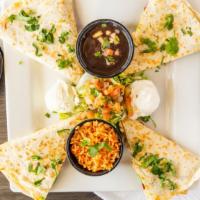 California Quesadilla · Grilled chicken, Monterey jack cheese bacon and sliced avocados inside a twelve inches flour...