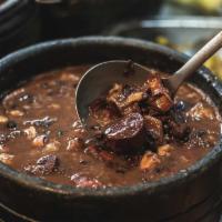 Black Beans With Pork · Expertly cooked and seasoned black beans with bacon and smoked sausage.