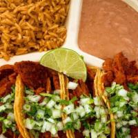 Taco Plate · Four street tacos with a choice of protein a side of rice and beans with cilantro and onion ...
