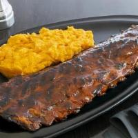 Ribs · a full rack of slow roasted baby back ribs smothered in BBQ sauce, served with sweet potato ...
