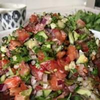 Afghani Salad · Chopped salad, cucumber, tomato, onion, and seasoning mixed with ollive oil and lemon juice.