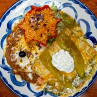 Enchiladas Suizas · Enchiladas prepared with seasoned shredded chicken and green chilies, topped with salsa verd...