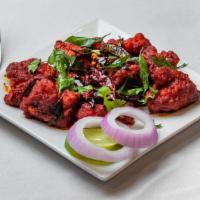 Chicken 65 · Boneless cubes of chicken sautéed in a chef's special 555 sauce with red chili paste.