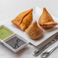 Samosa · 3 pieces. Deep-fried cone pastry stuffed with potatoes and green peas.