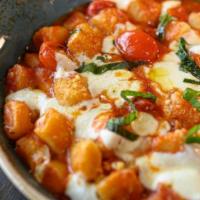 Gnocchi · Homemade ricotta gnocchi, baked in tomato sauce with fresh mozarella.
