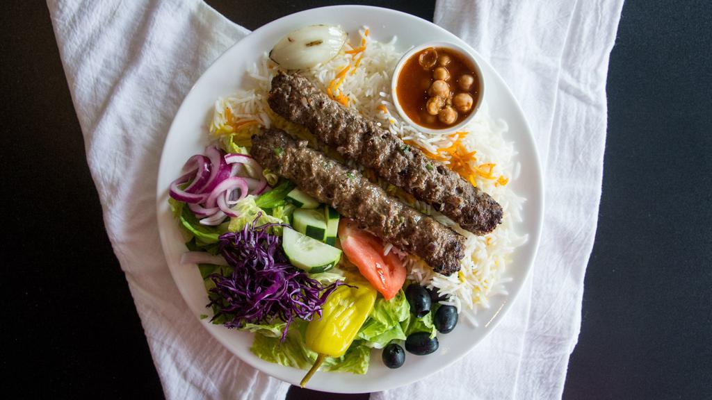 Ground Beef Kabob Salad · Ground beef two skewers withMix Green & Iceburg lettuce : Cucumber Onion Tomato feta cheese black olives & peperocine . Served with fresh pita bread and house dressing on the side salad and bread no rice