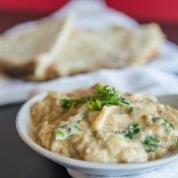 Hummus With Oven Baked Pita Bread · Chickpeas puréed with fresh garlic, lemon juice and kosher salad.