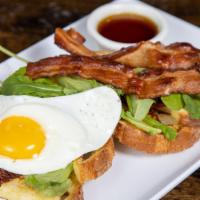 Blt French Toast · Thick slices of french toast topped with bacon, arugula, oven-dried tomatoes and an egg cook...