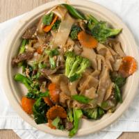 Pad See-Ew (Soy Sauce Noodles) · Flat rice noodles stir fried with house soy sauce, carrot, broccoli, Chinese broccoli, and e...