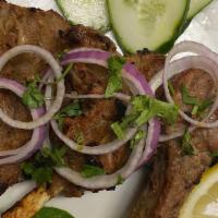Lamb Chops · Lamb chops marinated in yogurt and spices, grilled on skewers.