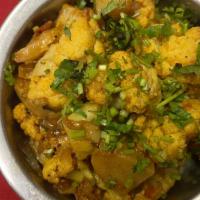 Aloo Gobi · Delicately hand pulled fresh cauliflower and potatoes simmered in herbs and spices.