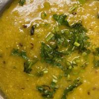 Tadka Dal · Slow simmered yellow lentils sauteed with fresh garlic and ginger.