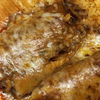 Tamales Pollo · Two chicken tamales  topped whit red sauce, rice and beans