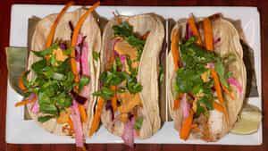 Cancun Tacos · Farmed raised tilapia, topped with chipotle mayo, jicama slaw, and cilantro.