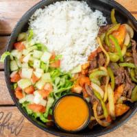 Dominican Bowl · Grill steak with onions & peppers, rice, beans and salad
