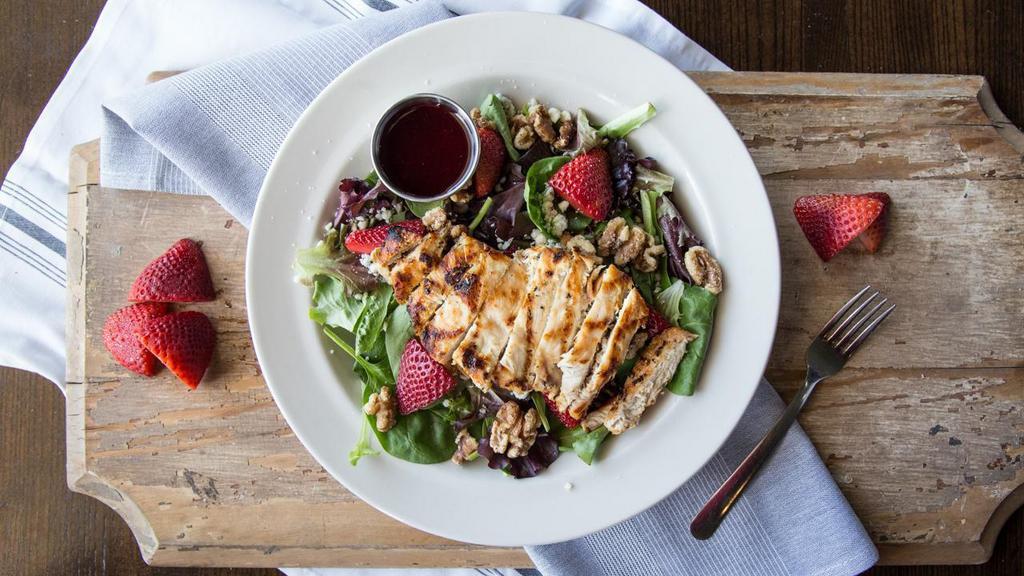Raspberry Chicken Salad · Grilled chicken, spring mix, blue cheese crumbles, honey walnuts, sliced strawberries. Served with a raspberry vinaigrette.