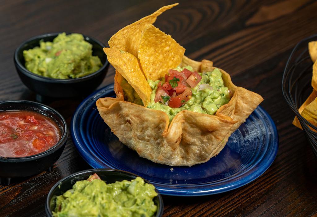 Guacamole Dip · Guacamole Dip- Ripe Hass avocado, onions, tomatoes, cilantro, and fresh lime.  Served in a crispy flour tortilla bowl with corn tortilla chips.