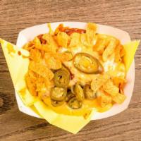 Frito Pie · Fritos covered with hot chile con carne hot melted cheese and jalapeños