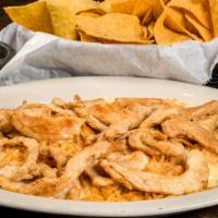 Pollo Con Arroz · A bed of rice with strips of grilled chicken and white queso.