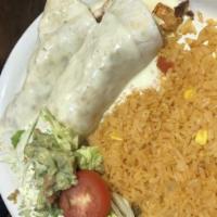 Burrito Ranchero · 12 flour tortilla filled with steak, grilled chicken and chorizo. Covered with cheese sauce....