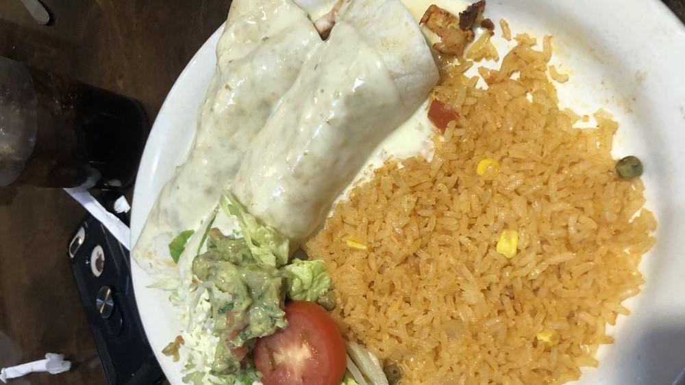 Burrito Ranchero · 12 flour tortilla filled with steak, grilled chicken and chorizo. Covered with cheese sauce. Served with rice.