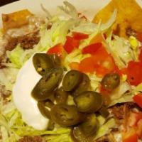 Burrito De Carnitas · Flour tortilla filled with carnitas inside. Topped with white queso. Served with rice, beans...