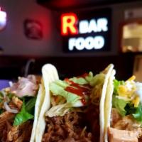 Asian Pulled Pork · Smoked pulled pork in R owns teriyaki-BBQ sauce topped with Asian peanut coleslaw and srirac...