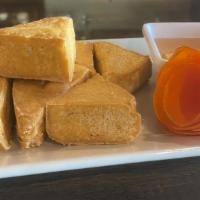 Tofu Fries · Deep fried tofu strips served with chili sauce.