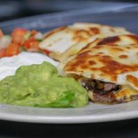 Quesadilla · Grilled flour tortilla filled with cheese, served with guacamole, sour cream, and pico de ga...
