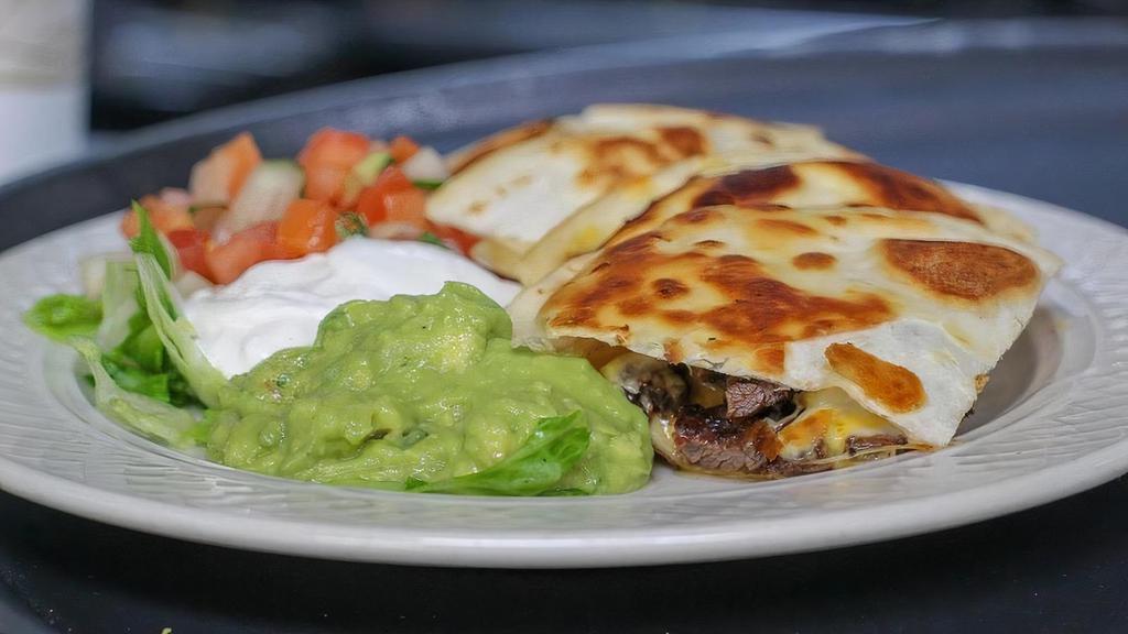 Quesadilla · Grilled flour tortilla filled with cheese, served with guacamole, sour cream, and pico de gallo.