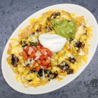 Nachos · Corn tortilla chips covered with beans and melted cheese served with guacamole, sour cream, ...