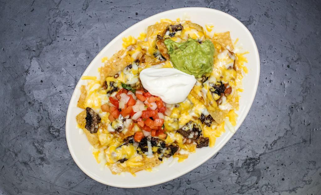 Nachos · Corn tortilla chips covered with beans and melted cheese served with guacamole, sour cream, and pico de gallo.