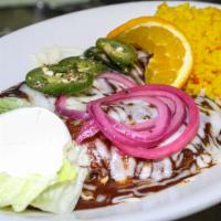 Mole Enchiladas* · Two fresh corn tortillas wrapped around shredded chicken and topped with a traditional Mole ...